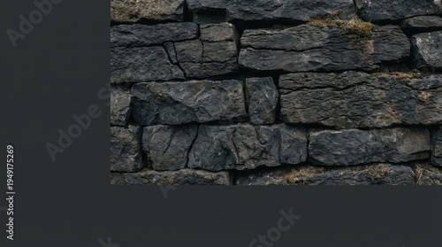 Close-Up View of Textured Dark Stone Wall with Natural Irregularities and Moss Growth in an Earthy Setting