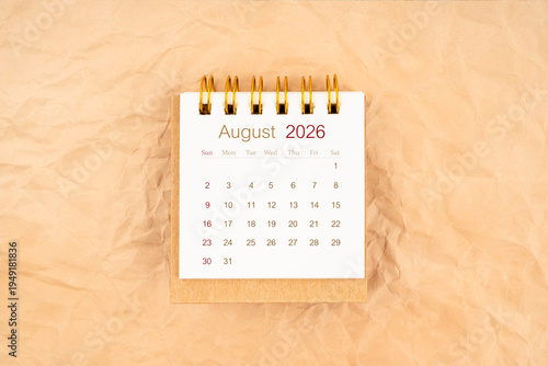 August 2026 mini desk calendar on old paper.
