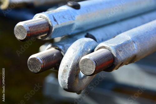 Photos Group of disassembled metal pipes stacked on the ground at an industrial site, s