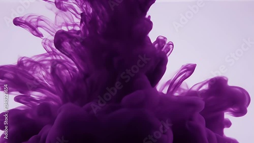 Abstract macro shot shows swirling purple liquid in a light background, resembling smoke