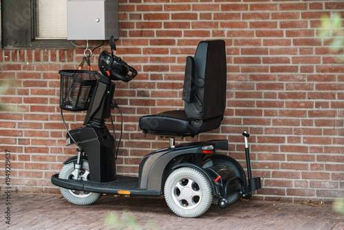 Assistive Mobility Electric Scooter Parked Outside Building