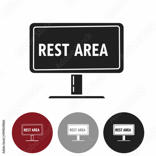 Rest area sign. A rectangular black sign with the words REST AREA prominently displayed in white