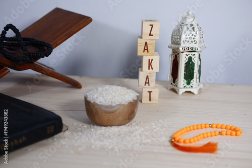 Bild auf Leinwand Zakat background concept: Rice on a wooden bowl, prayer beads, dhikr, lanterns, and scattered coins
