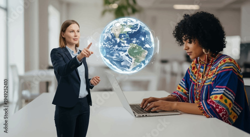 Two businesswomen interacting with a holographic globe in an office setting