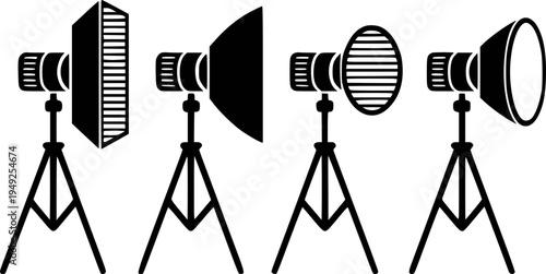 Collection of black studio lighting equipment tripod stands