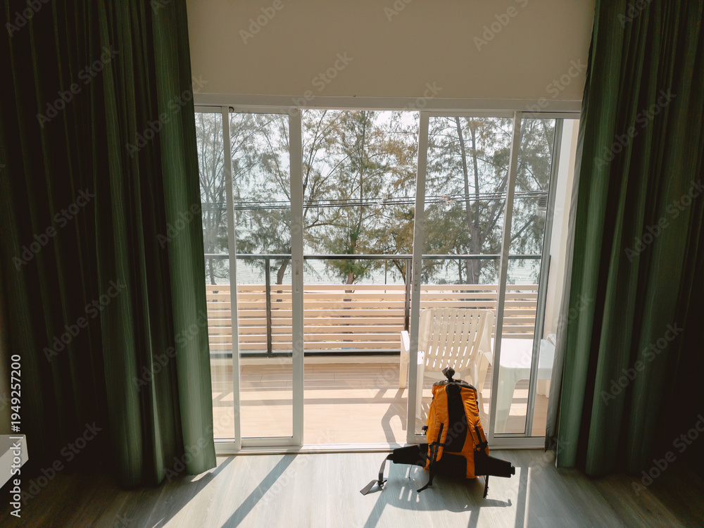 Fototapeta premium Quiet travel preparations in sunlit hotel room with nature nearby