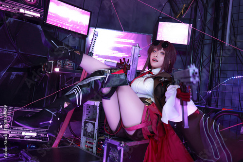 Canvas Print Girl in cosplay outfit sits on computer desk with sword