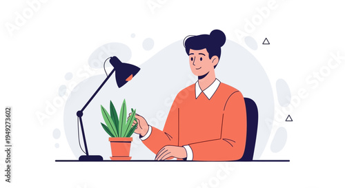 Young man tending to a potted plant at his desk with a desk lamp.