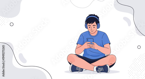 Young man listening to music on headphones and using smartphone, sitting cross-legged