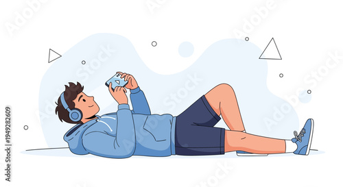 Young man with headphones lying down and playing on smartphone, relaxing lifestyle