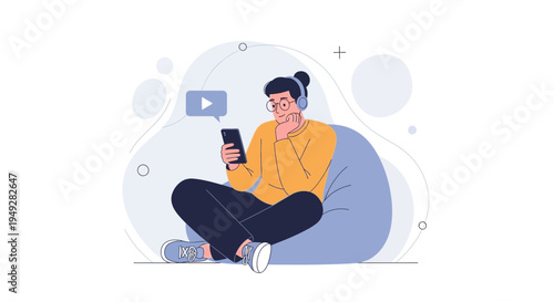 Young man with headphones watching video on smartphone while sitting on bean bag