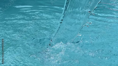 Close up of flowing water in swimming pool creating ripples and relaxing texture in 4K.