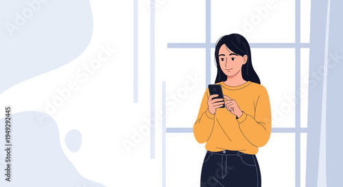 Young woman in yellow sweater using smartphone, standing near window with abstract background