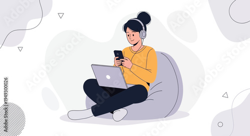 Young woman with headphones using phone and laptop while sitting on beanbag chair