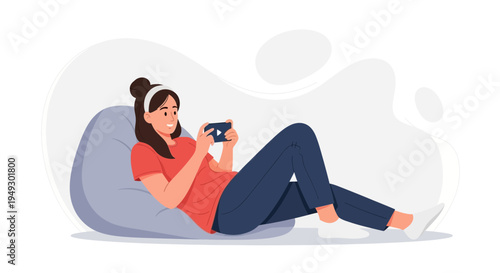 Young woman relaxing on bean bag chair playing mobile game on smartphone