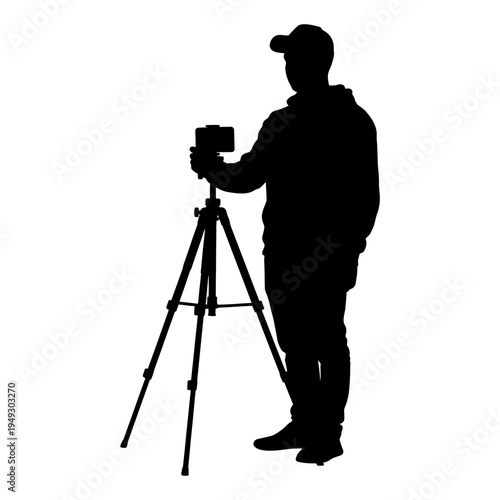 Black silhouette of a male photographer or videographer using a camera on a tripod for content creation, vlogging, and professional video production.