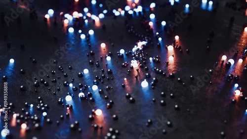 An abstract dark surface with rolling small neon balls of blue and orange. Looping animation.