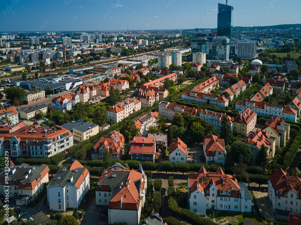 Obraz premium Aerial view of residential apartment buildings with red roofs and modern office skyscrapers including Olivia Star in the Oliwa district, Gdansk, Pomerania, Poland, Europe.
