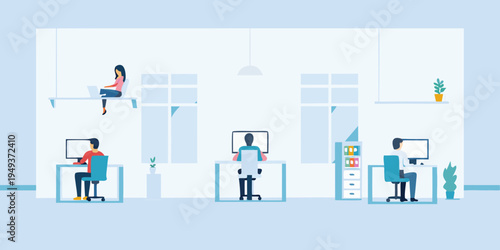 Modern office space with several people working at desks and a relaxed setting