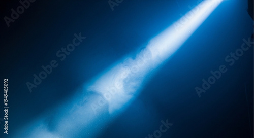 Bright Spotlight Beam Illuminating Dark Blue Background.