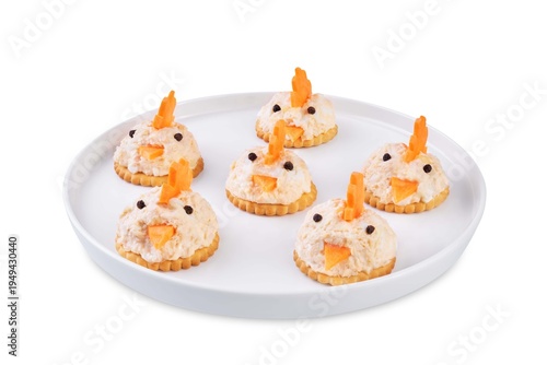 Salmon egg salad with crackers in the form of chicks in the plate on a white isolated background