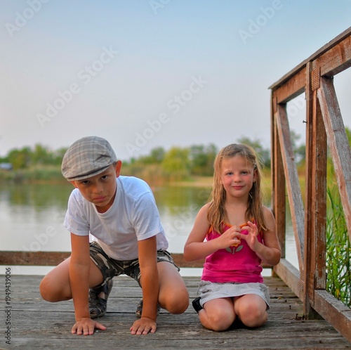 Принти на полотні Children sitting on pier