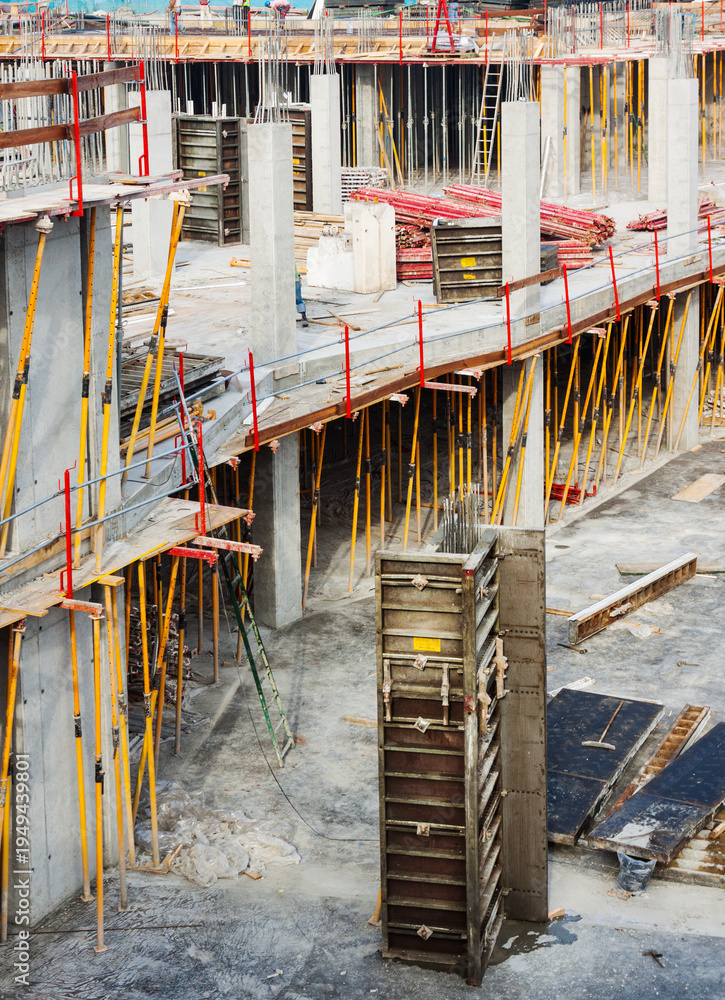 Fototapeta premium Extensive concrete construction site with scaffolding and formwork in progress building structure