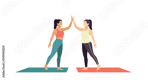 Two women practicing yoga giving high five on exercise mats