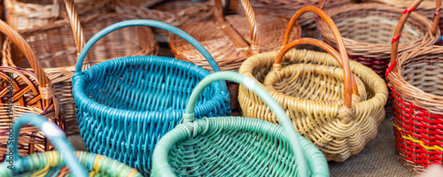 Handmade wicker baskets handles displayed outdoor craft market stall traditional weaving technique natural willow material. Rustic artisan products sale sustainable household storage picnic baskets