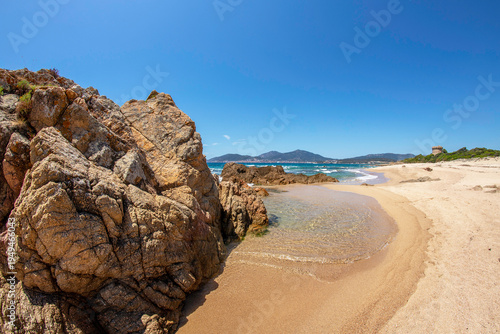 Idyllic sandy beach with turquoise water and rocky coastline near Ajaccio, Corsica, Mediterranean summer landscape