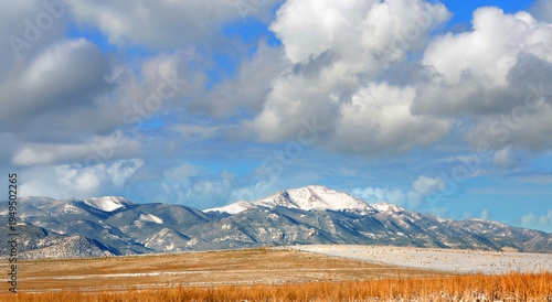 Fotografie Blue Sky and Clouds Hover Over Pike's Peak