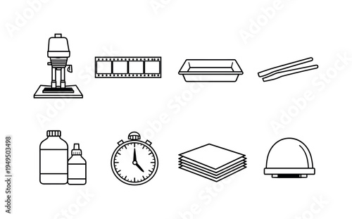 Retro film darkroom: enlarger, film negative strip, developing tray, tongs, chemical bottles, timer, photo paper stack, safelight lamp