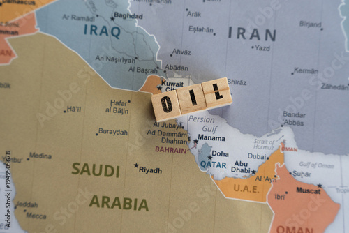 Wooden letter blocks spelling OIL placed on a map of the Middle East, specifically over the Persian Gulf region, symbolizing global energy supply, OPEC production, and geopolitical stability
