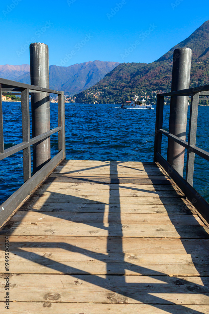 Fototapeta premium Wooden pier overlooking the Alps and Lake Como in Italy