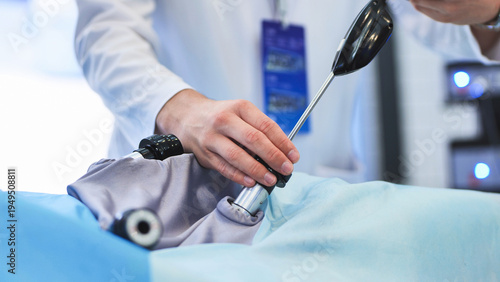 Surgeon performing laparoscopic surgery using advanced medical equipment in operating room