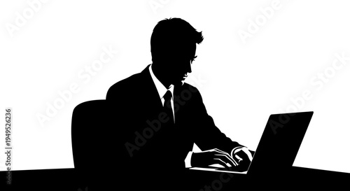 Silhouette of a businessman working on a laptop at a desk, representing focus and productivity.