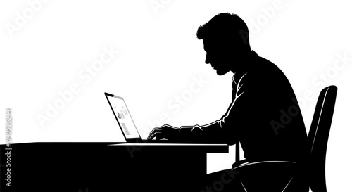 Silhouette of a businessman working on a laptop at his desk in an office