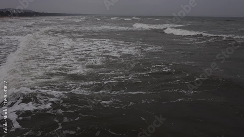 Ocean waves moving toward shoreline from drone. Aerial ocean waves motion.