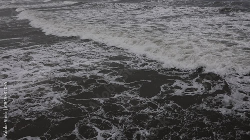 Ocean wave breaking with foam from drone above. Aerial breaking wave closeup.