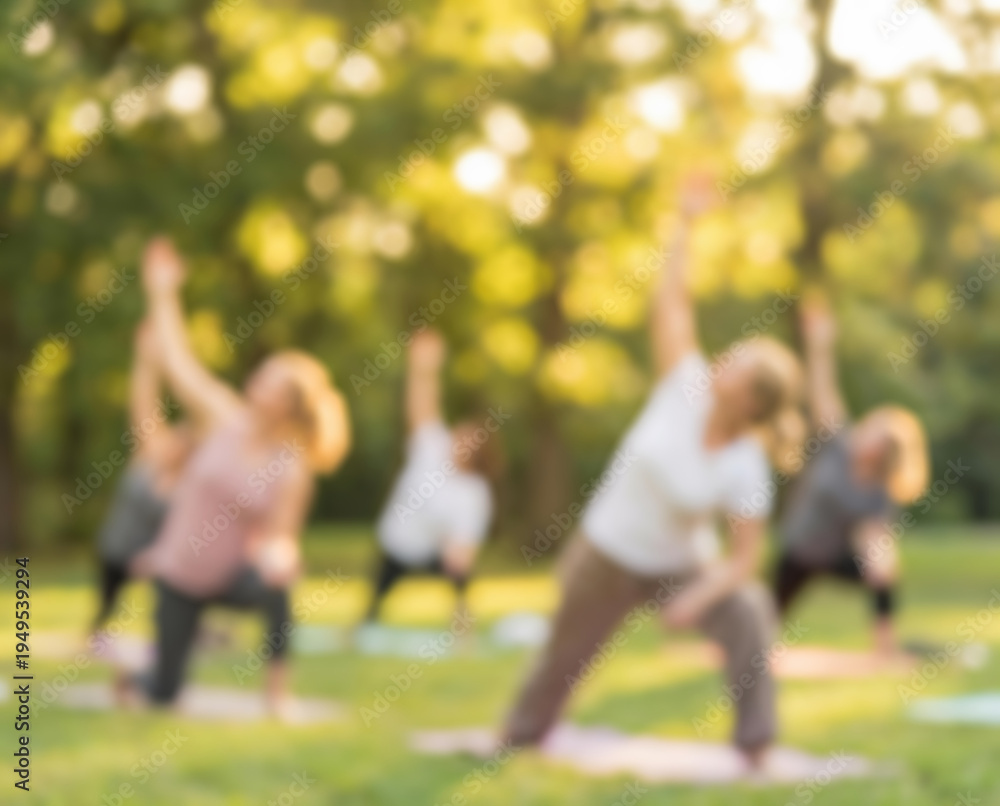 Obraz premium Women practicing yoga outdoors in a park at sunset