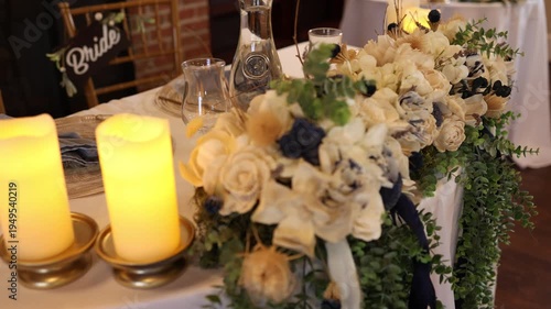 Romantic wedding table centerpiece with candles and flowers