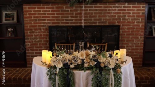 Rustic wedding sweetheart table with flowers and candles