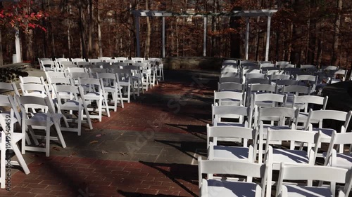 Outdoor wedding ceremony chairs and brick aisle in autumn