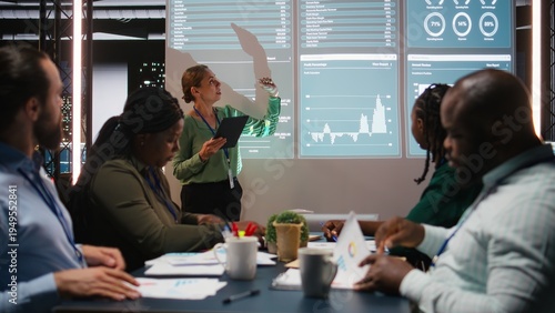 Photography Team of company analysts review feedback on data insights to work on future improvements, developing marketing and PR strategies in meeting room