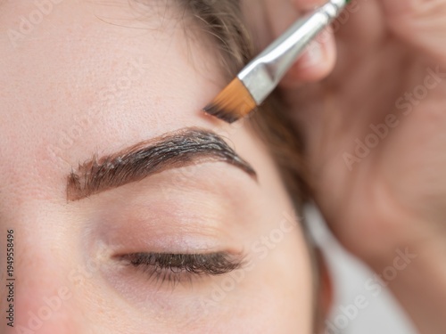 Caucasian woman getting eyebrow tinting procedure. 