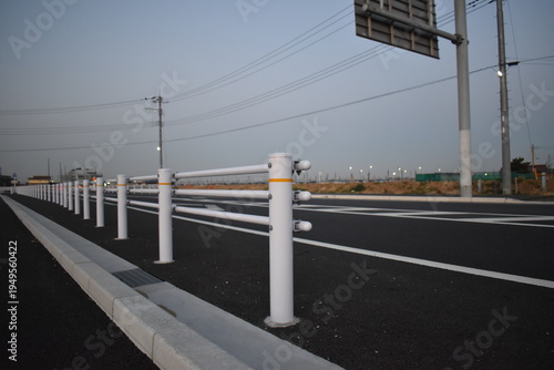 Tableau sur toile White guardrail on asphalt road at dusk in Japan