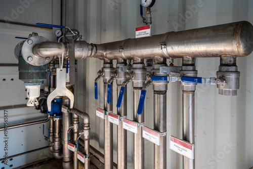 Industrial stainless steel hydraulic manifold system with ball valves.