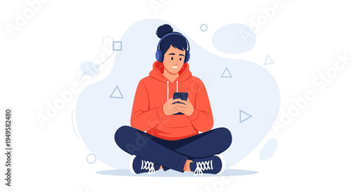 Young person with headphones listening to music on phone, sitting cross-legged