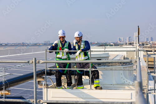 Industrial Technicians Standing on Rooftop Facility Platform