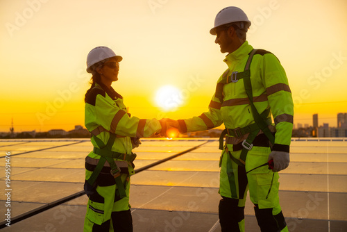 Solar Technicians Shaking Hands at Sunset